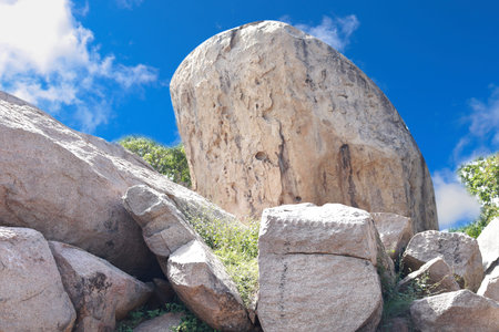 Very large boulders. And blue sky. In the middle of nature.