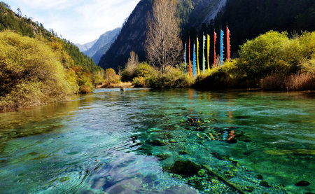 Prayer flags reflected in Jiuzhaigou's crystal waters