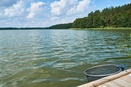 Empty footbridge over Lemiet beautiful lake in Masuria district, Poland. Fantastic travel destination.の写真素材