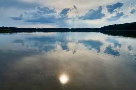 Beautiful panoramic view of the sunset over Lemiet lake lake in Masuria district, Poland. Lake landscape at sunset, fantastic travel destination.の写真素材