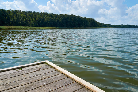 Empty footbridge over Lemiet beautiful lake in Masuria district, Poland. Fantastic travel destination.の写真素材