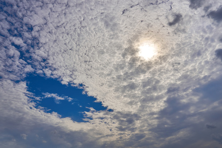 A beautiful view of the summer sun behind the cloudsの写真素材