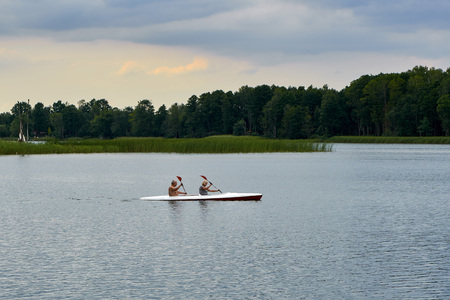 Biale, Poland - August 04, 2017: An elderly couple is floating on a kayak on the lBiale Lake, Poland in hot Augustのeditorial素材