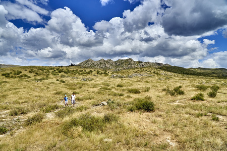 Beautiful landscape of steppe and stone mountains along the road from the city of Ust-Kamenogorsk to the Sibiny lakes (RU: Sibinskiye Ozora: Sadyrkol, Tortkara, Shalkar, Korzhynkol), East Kazakhstanの写真素材