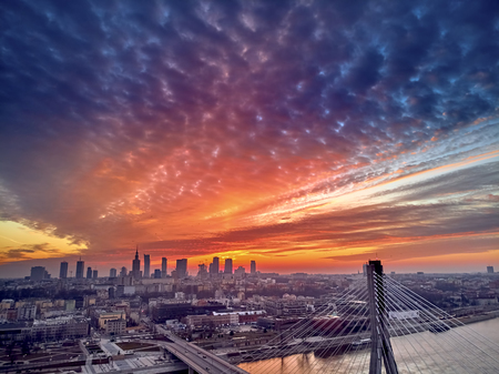 Beautiful panoramic aerial drone sunset view to Warsaw city center with skyscrapers and Swietokrzyski Bridge (En: Holy Cross Bridge) - is a cable-stayed bridge over the Vistula river in Warsaw, Polandの写真素材