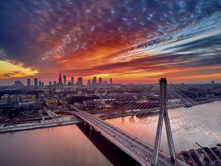 Beautiful panoramic aerial drone sunset view to Warsaw city center with skyscrapers and Swietokrzyski Bridge (En: Holy Cross Bridge) - is a cable-stayed bridge over the Vistula river in Warsaw, Polandの写真素材