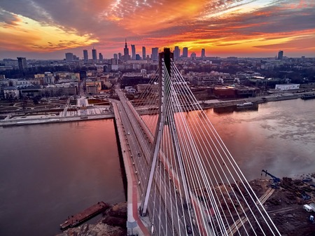 Beautiful panoramic aerial drone sunset view to Warsaw city center with skyscrapers and Swietokrzyski Bridge (En: Holy Cross Bridge) - is a cable-stayed bridge over the Vistula river in Warsaw, Polandの写真素材