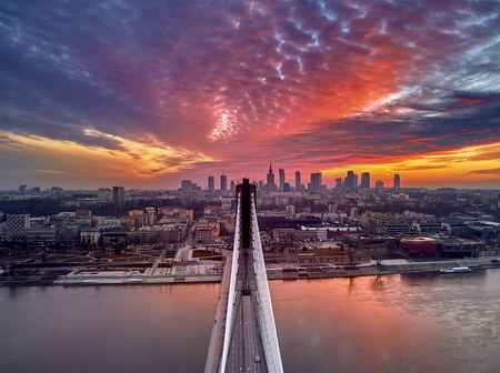 Beautiful panoramic aerial drone sunset view to Warsaw city center with skyscrapers and Swietokrzyski Bridge (En: Holy Cross Bridge) - is a cable-stayed bridge over the Vistula river in Warsaw, Polandの写真素材
