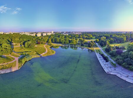 A beautiful panoramic view of the sunset in a fabulous evening in June from drone at Pola Mokotowskie in Warsaw, Poland - "Mokotow Field" is a large park in Warsaw - Is called "Jozef Pilsudski Park"の写真素材