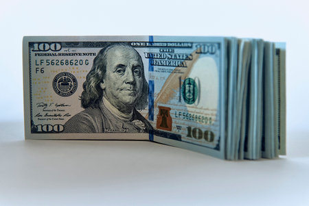 Stack of one hundred dollar bills new design on a white background