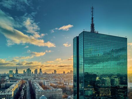 Beautiful panoramic aerial drone view to the ?enter of modern Warsaw city with silhouettes of skyscrapers in in the rays of the setting winter January sun - amazing sunset, Polandの写真素材