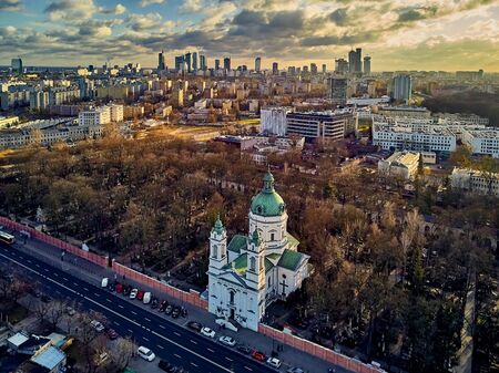 Beautiful panoramic aerial drone view to the ?enter of modern Warsaw city with silhouettes of skyscrapers and Church Karol Boromeusz (at the Powazki Cemetery) in amazing winter January sunset, Polandの写真素材