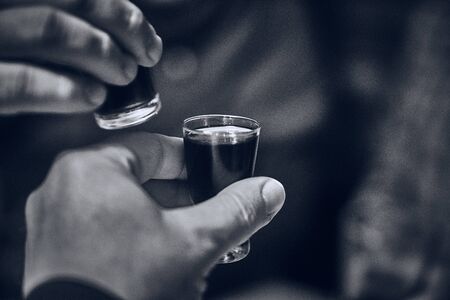 Bless you! A few hands knock on the glasses with vodkaの写真素材