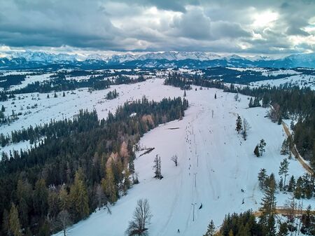 Beautiful panoramic aerial drone view to the ski slopes with lifts in the Bialka Tatrzanska ski resort Tatra Mountains (Tatras, Tatra) - mountain range between Slovakia and Poland, PLの写真素材