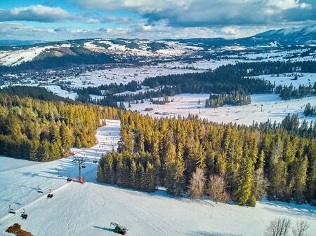 Beautiful panoramic aerial drone view to the ski slopes with lifts in the Bialka Tatrzanska ski resort Tatra Mountains (Tatras, Tatra) - mountain range between Slovakia and Poland, PLの写真素材