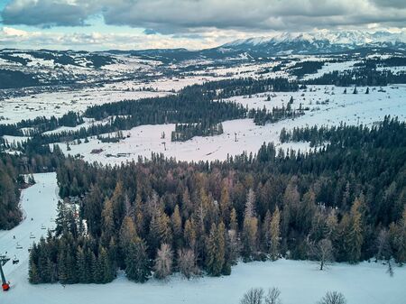 Beautiful panoramic aerial drone view to the ski slopes with lifts in the Bialka Tatrzanska ski resort Tatra Mountains (Tatras, Tatra) - mountain range between Slovakia and Poland, PLの写真素材