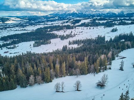 Beautiful panoramic aerial drone view to the ski slopes with lifts in the Bialka Tatrzanska ski resort Tatra Mountains (Tatras, Tatra) - mountain range between Slovakia and Poland, PLの写真素材