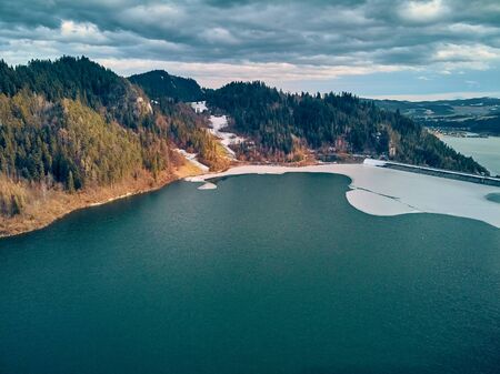 Beautiful panoramic aerial drone view to the Czorsztyn Lake with a reservoir and dam, Tatra Mountains (Tatras, Tatra) - mountain range between Slovakia and Poland, PLの写真素材