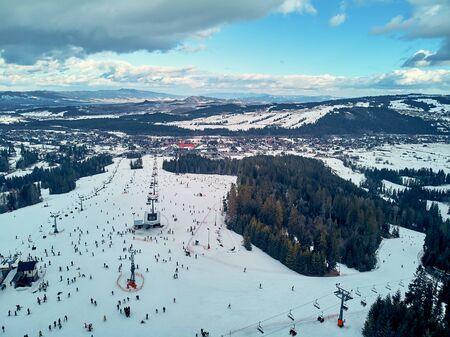 Beautiful panoramic aerial drone view to the ski slopes with lifts in the Bialka Tatrzanska ski resort Tatra Mountains (Tatras, Tatra) - mountain range between Slovakia and Poland, PLの写真素材