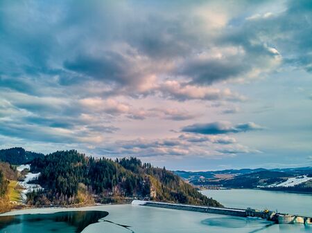 Beautiful panoramic aerial drone view to the Czorsztyn Lake with a reservoir and dam, Tatra Mountains (Tatras, Tatra) - mountain range between Slovakia and Poland, PLの写真素材
