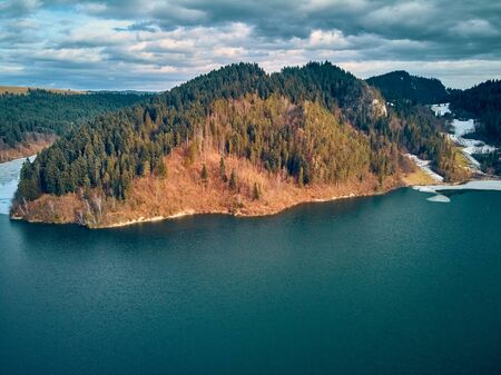 Beautiful panoramic aerial drone view to the Czorsztyn Lake with a reservoir and dam, Tatra Mountains (Tatras, Tatra) - mountain range between Slovakia and Poland, PLの写真素材