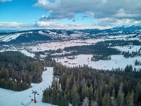 Beautiful panoramic aerial drone view to the ski slopes with lifts in the Bialka Tatrzanska ski resort Tatra Mountains (Tatras, Tatra) - mountain range between Slovakia and Poland, PLの写真素材