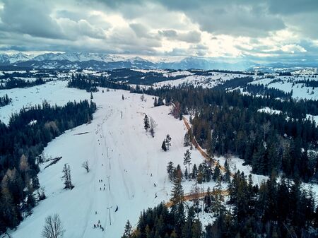 Beautiful panoramic aerial drone view to the ski slopes with lifts in the Bialka Tatrzanska ski resort Tatra Mountains (Tatras, Tatra) - mountain range between Slovakia and Poland, PLの写真素材