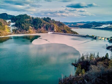 Beautiful panoramic aerial drone view to the Czorsztyn Lake with a reservoir and dam, Tatra Mountains (Tatras, Tatra) - mountain range between Slovakia and Poland, PLの写真素材