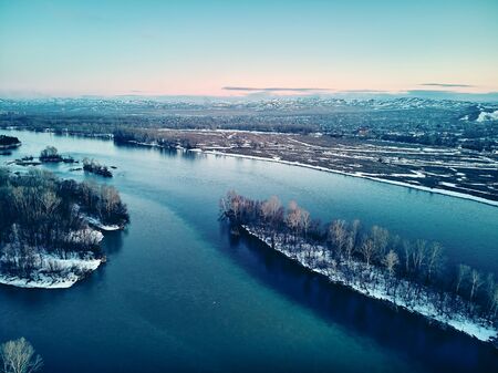 Panoramic aerial view: beautiful spring landscape: the Irtysh river in Kazakhstan wakes up from winter sleep - ice drift - snow and ice are melting at sunset, Qazaqstanの写真素材