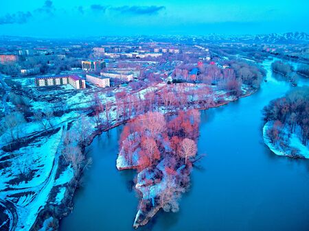 Panoramic aerial view: beautiful spring landscape: the Irtysh river in Kazakhstan wakes up from winter sleep - ice drift - snow and ice are melting at sunset, Qazaqstanの写真素材