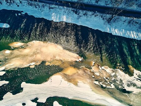 Panoramic aerial view: beautiful spring landscape: the Ulba river in Kazakhstan wakes up from winter sleep - ice drift - snow and ice are melting in the mountains, the bright sun is shining, Qazaqstanの写真素材