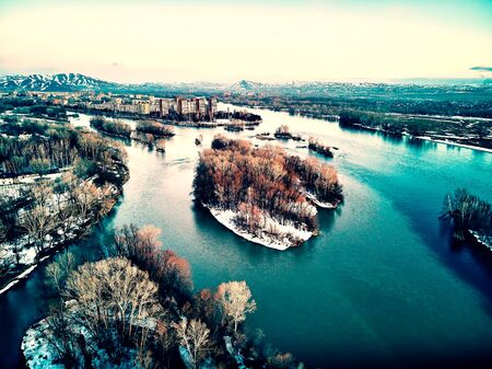 Panoramic aerial view: beautiful spring landscape: the Irtysh river in Kazakhstan wakes up from winter sleep - ice drift - snow and ice are melting at sunset, Qazaqstanの写真素材