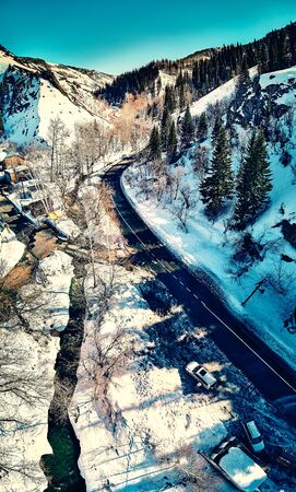 Panoramic aerial view: beautiful spring landscape: the Ulba river in Kazakhstan wakes up from winter sleep - ice drift - snow and ice are melting in the mountains, the bright sun is shining, Qazaqstanの写真素材
