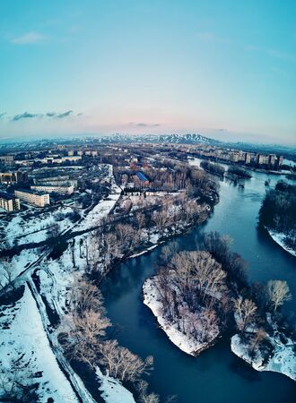 Panoramic aerial view: beautiful spring landscape: the Irtysh river in Kazakhstan wakes up from winter sleep - ice drift - snow and ice are melting at sunset, Qazaqstanの写真素材