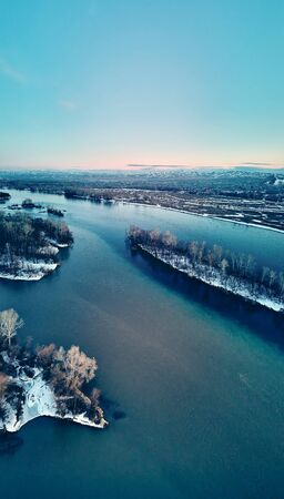 Panoramic aerial view: beautiful spring landscape: the Irtysh river in Kazakhstan wakes up from winter sleep - ice drift - snow and ice are melting at sunset, Qazaqstanの写真素材