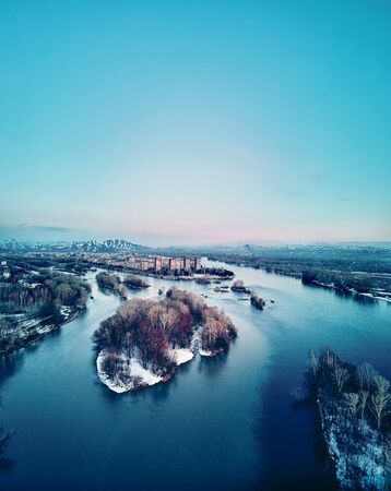 Panoramic aerial view: beautiful spring landscape: the Irtysh river in Kazakhstan wakes up from winter sleep - ice drift - snow and ice are melting at sunset, Qazaqstanの写真素材