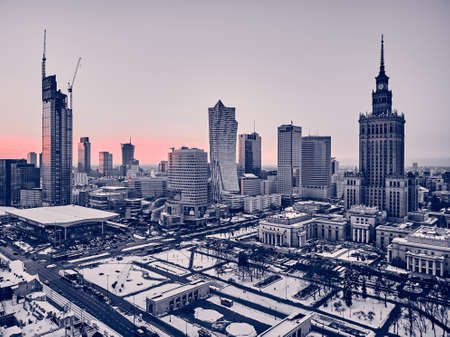 WARSAW, POLAND - JANUARY 31, 2021: Beautiful panoramic aerial drone view on Warsaw City Skyscrapers, PKiN, and Varso Tower under construction and 19th-century tenement houses during the January sunsetのeditorial素材