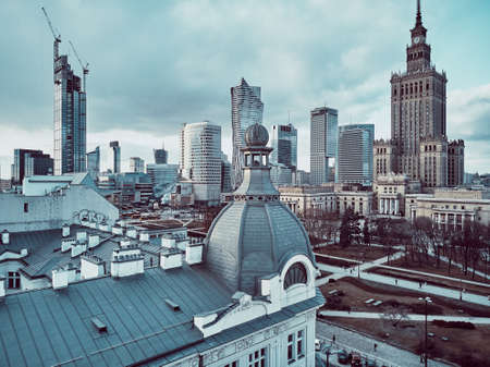 Beautiful panoramic aerial drone view on Warsaw City Skyscrapers, PKiN, and Varso Tower under construction and 19th-century tenement houses during the february sunset, Warsaw, Polandのeditorial素材