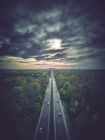Beautiful panoramic aerial drone skyline sunset view of the road to the Polish Capital - Warsaw City Center with skyscrapers of the Warsaw City on the horizon, Poland, EU - in stylized color.の写真素材
