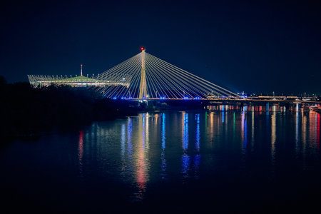 Beautiful panoramic night aerial view from drone of Narodowy Stadium - panorama with reflection in Vistula river, Warsaw, Poland, European Union.の写真素材