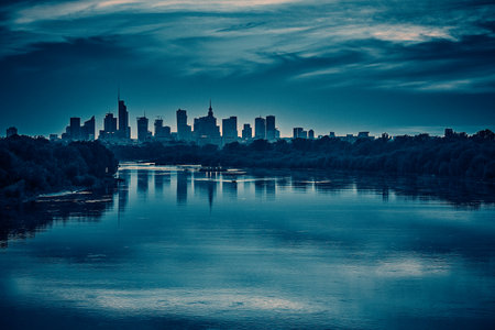 Beautiful panoramic aerial drone view of skyscrapers panorama at sunset, with reflection in Vistula river, Warsaw, Poland.の写真素材