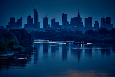 Beautiful panoramic aerial drone view of skyscrapers panorama at sunset, with reflection in Vistula river, Warsaw, Poland, EU.の写真素材