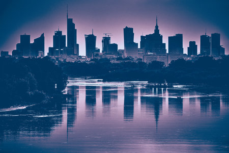 Beautiful panoramic aerial drone view of skyscrapers panorama at sunset, with reflection in Vistula river, Warsaw, Poland.の写真素材