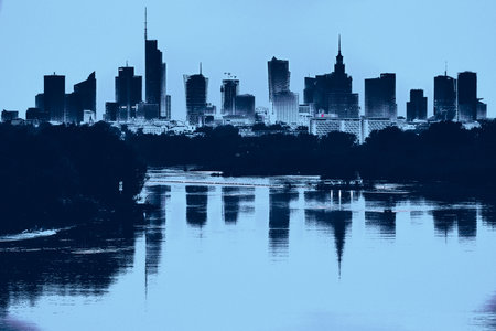 Beautiful panoramic aerial drone view of skyscrapers panorama at sunset, with reflection in Vistula river, Warsaw, Poland, EU.の写真素材