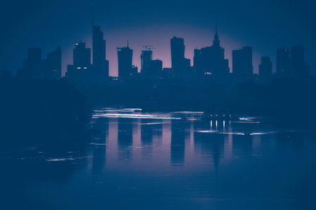 Beautiful panoramic aerial drone view of skyscrapers panorama at sunset, with reflection in Vistula river, Warsaw, Poland.の写真素材