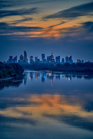 Beautiful panoramic aerial drone view of skyscrapers panorama at sunset, with reflection in Vistula river, Warsaw, Poland.の写真素材