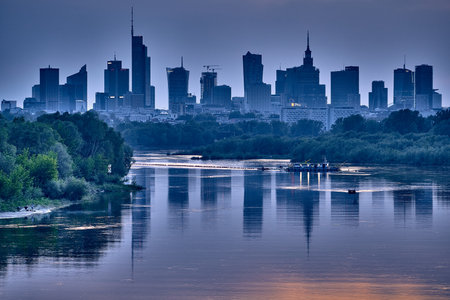 Beautiful panoramic aerial drone view of skyscrapers panorama at sunset, with reflection in Vistula river, Warsaw, Poland.の写真素材