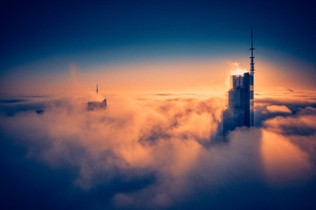 Panoramic aerial drone view of skyscrapers sticking out of low fog at sunrise, Warsaw, Poland, EU.の写真素材