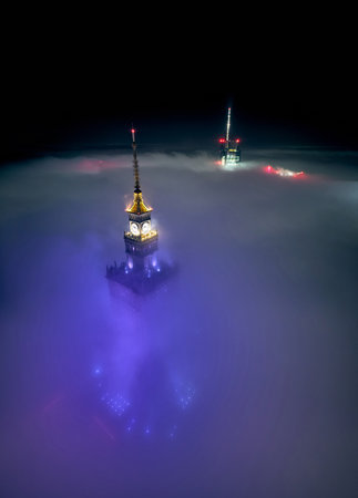 Panoramic aerial drone view of skyscrapers sticking out of low fog, Warsaw, Poland, EU.の写真素材
