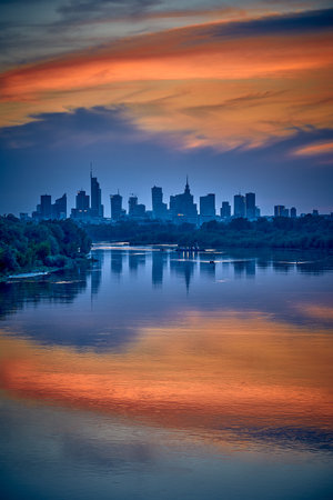 Beautiful panoramic aerial drone view of skyscrapers panorama at sunset, with reflection in Vistula river, Warsaw, Poland, EU.の写真素材